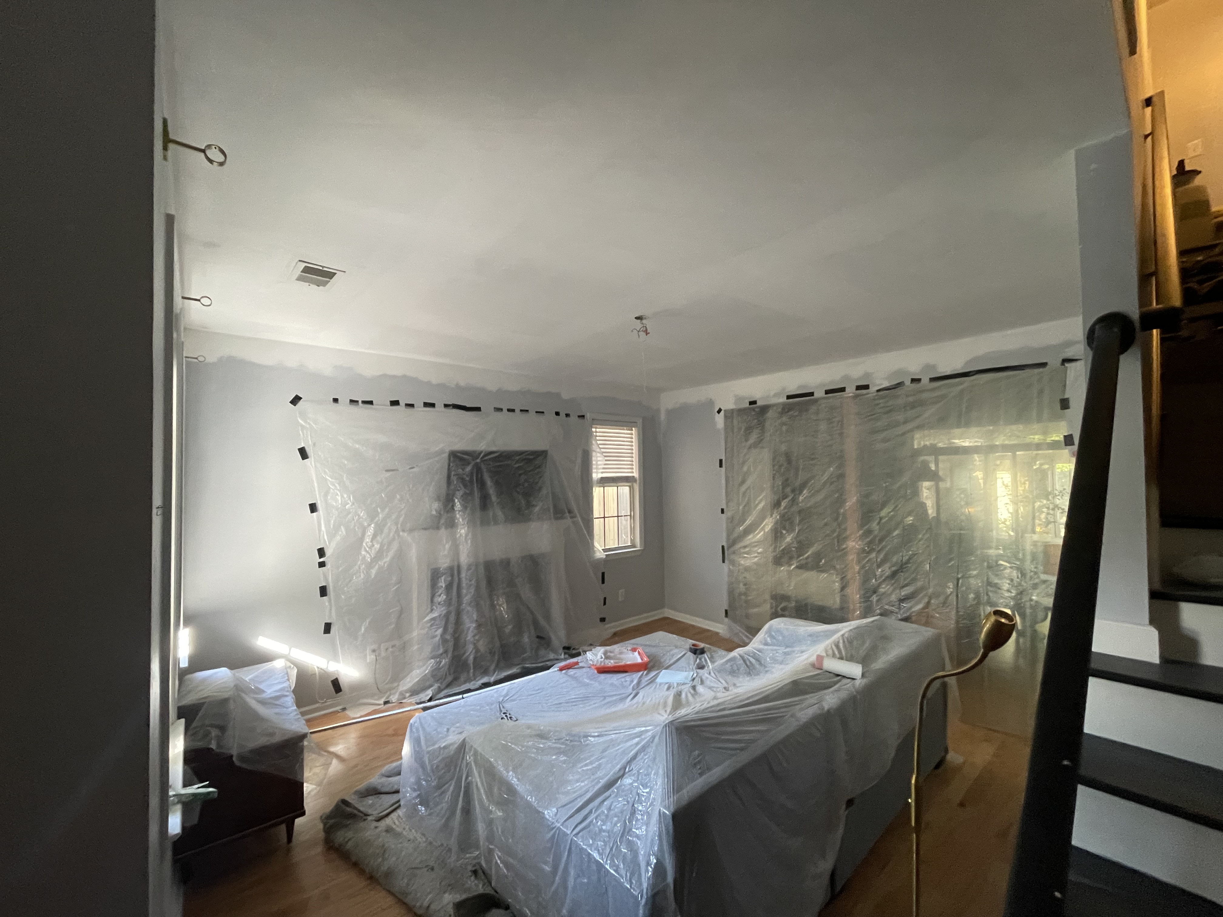 Room during renovation, popcorn ceiling removed and room prepped for paint